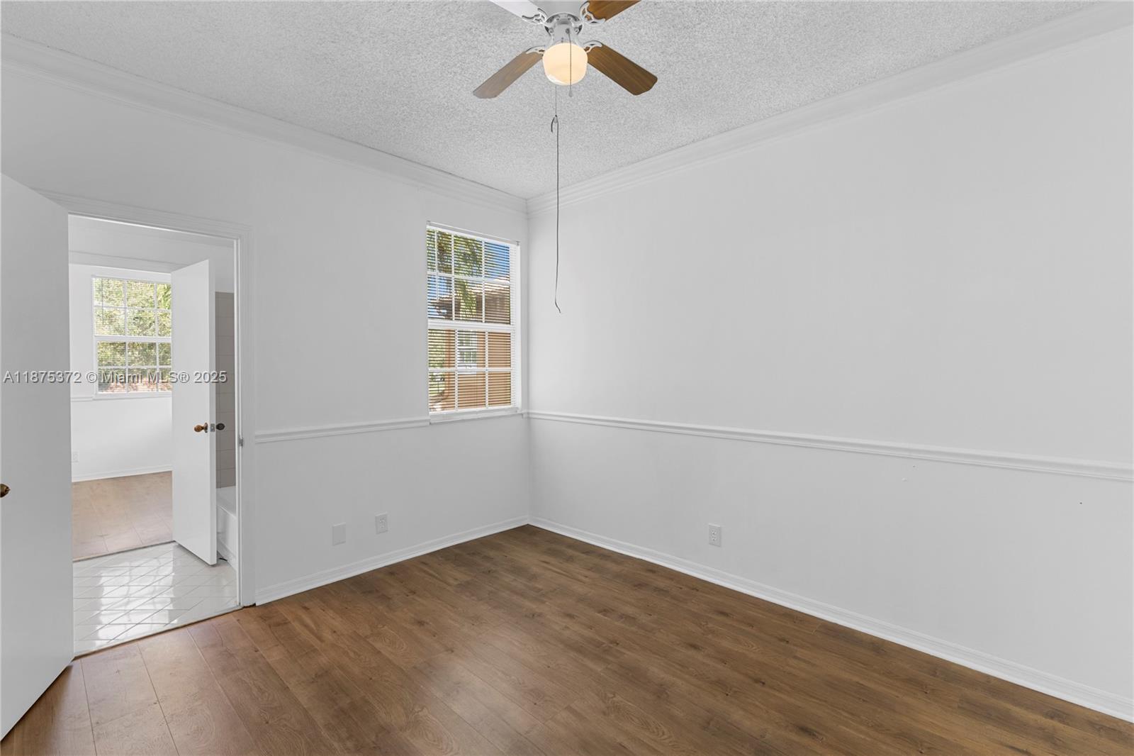 1440 Coronado Road, Unit 138 Weston, FL 33327 - Photo 20 of 38 wooden floor in an empty room with a window