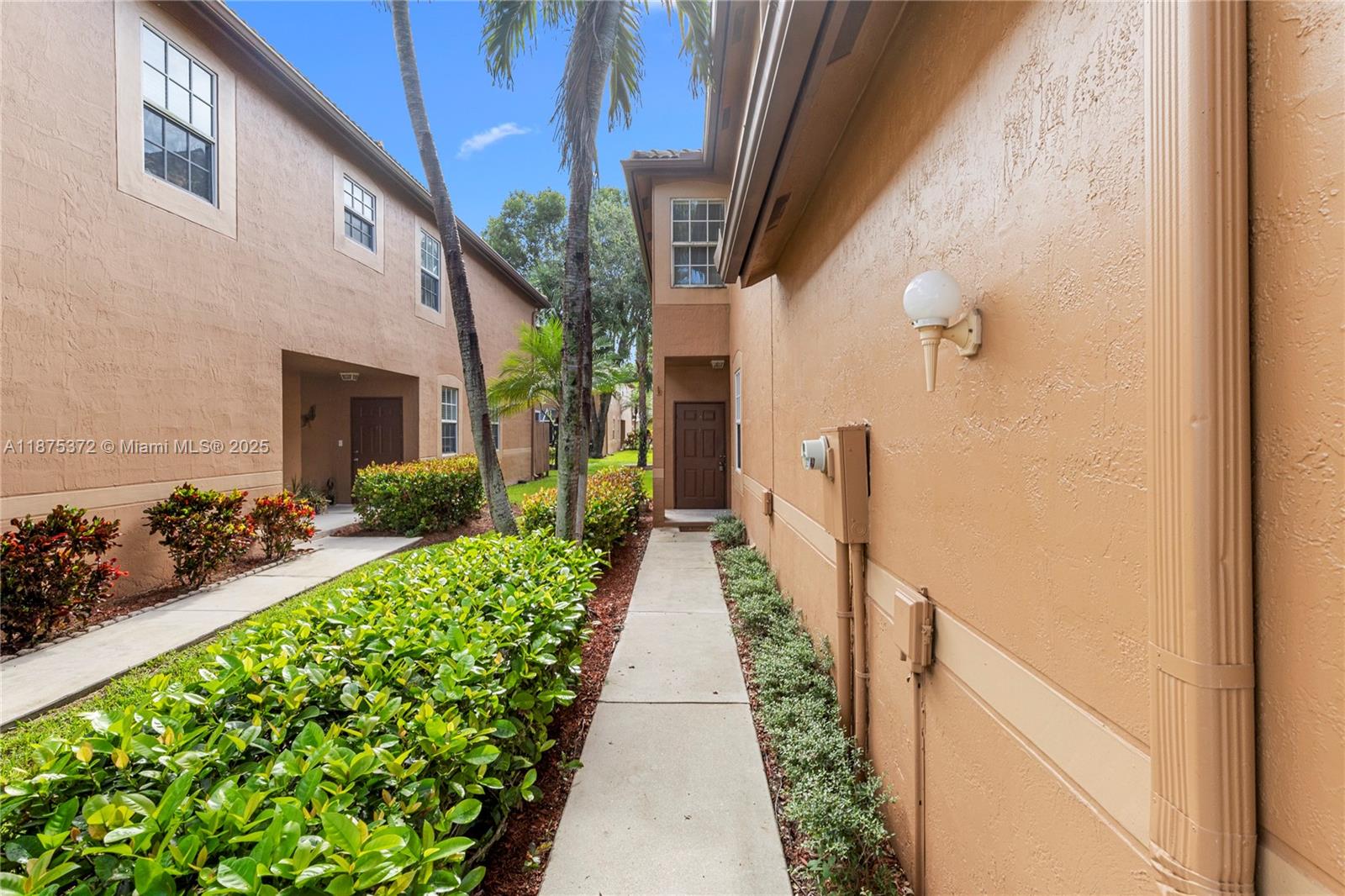 1440 Coronado Road, Unit 138 Weston, FL 33327 - Photo 2 of 38 a view of a pathway both side of the house