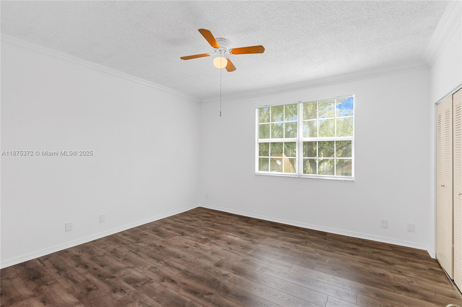1440 Coronado Road, Unit 138 Weston, FL 33327 - Photo 21 of 38 an empty room with wooden floor and windows