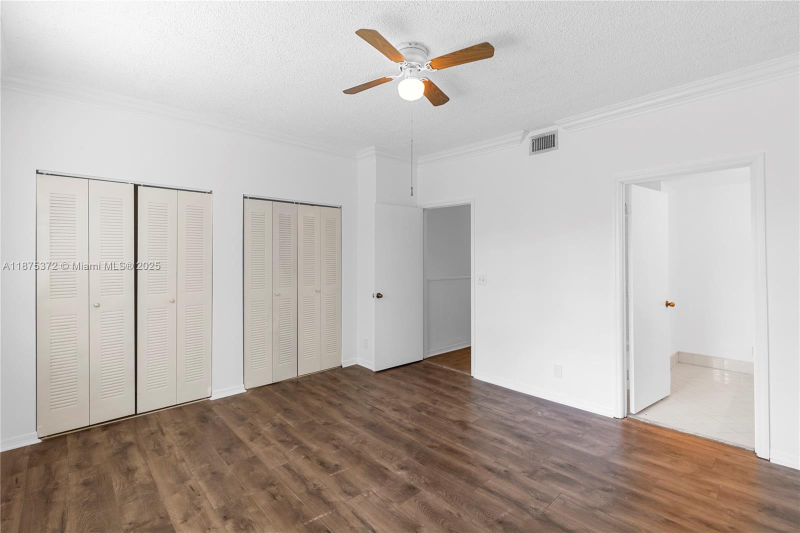 1440 Coronado Road, Unit 138 Weston, FL 33327 - Photo 22 of 38 a view of a room with wooden floor and a ceiling fan