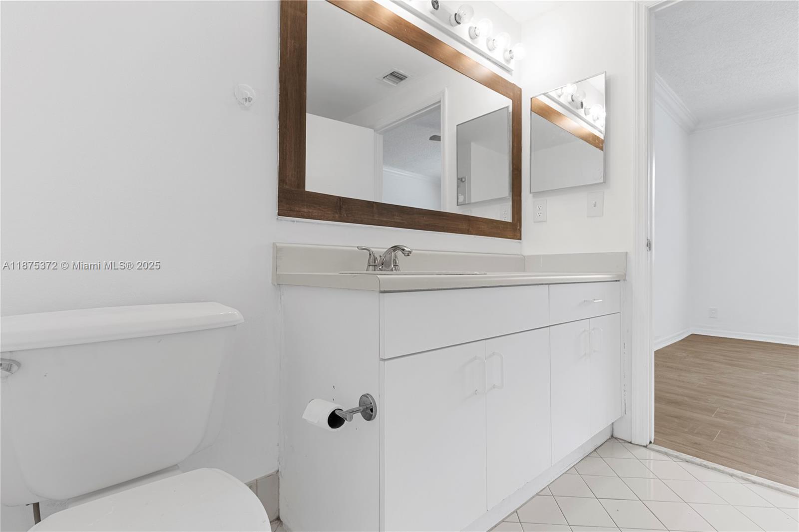 1440 Coronado Road, Unit 138 Weston, FL 33327 - Photo 26 of 38 a bathroom with a toilet sink and mirror