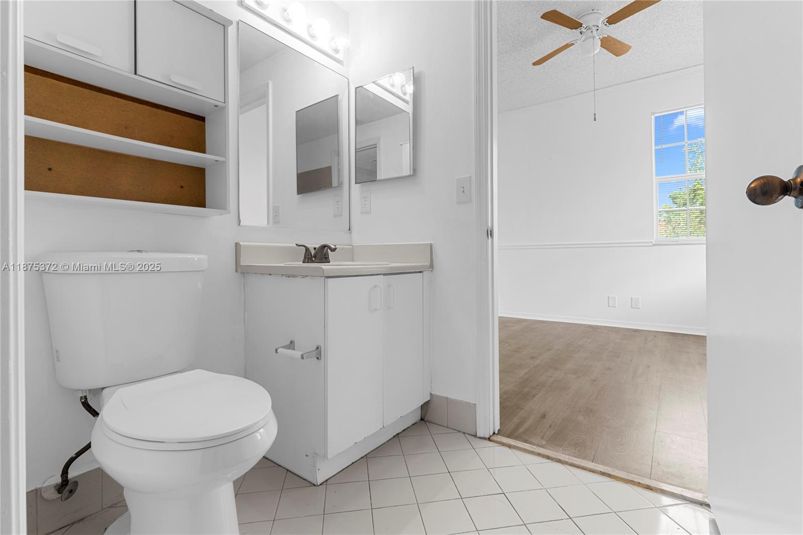 1440 Coronado Road, Unit 138 Weston, FL 33327 - Photo 27 of 38 a bathroom with a toilet a sink and mirror