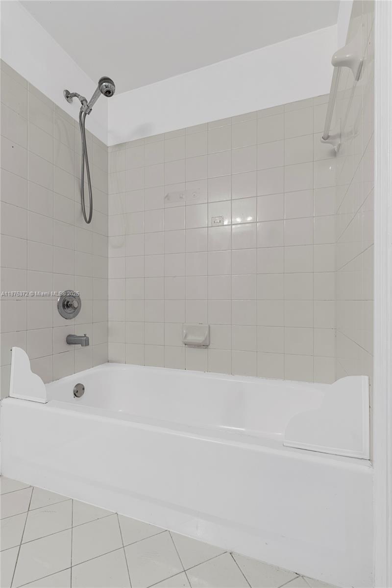 1440 Coronado Road, Unit 138 Weston, FL 33327 - Photo 28 of 38 a bathroom with a bathtub and a shower