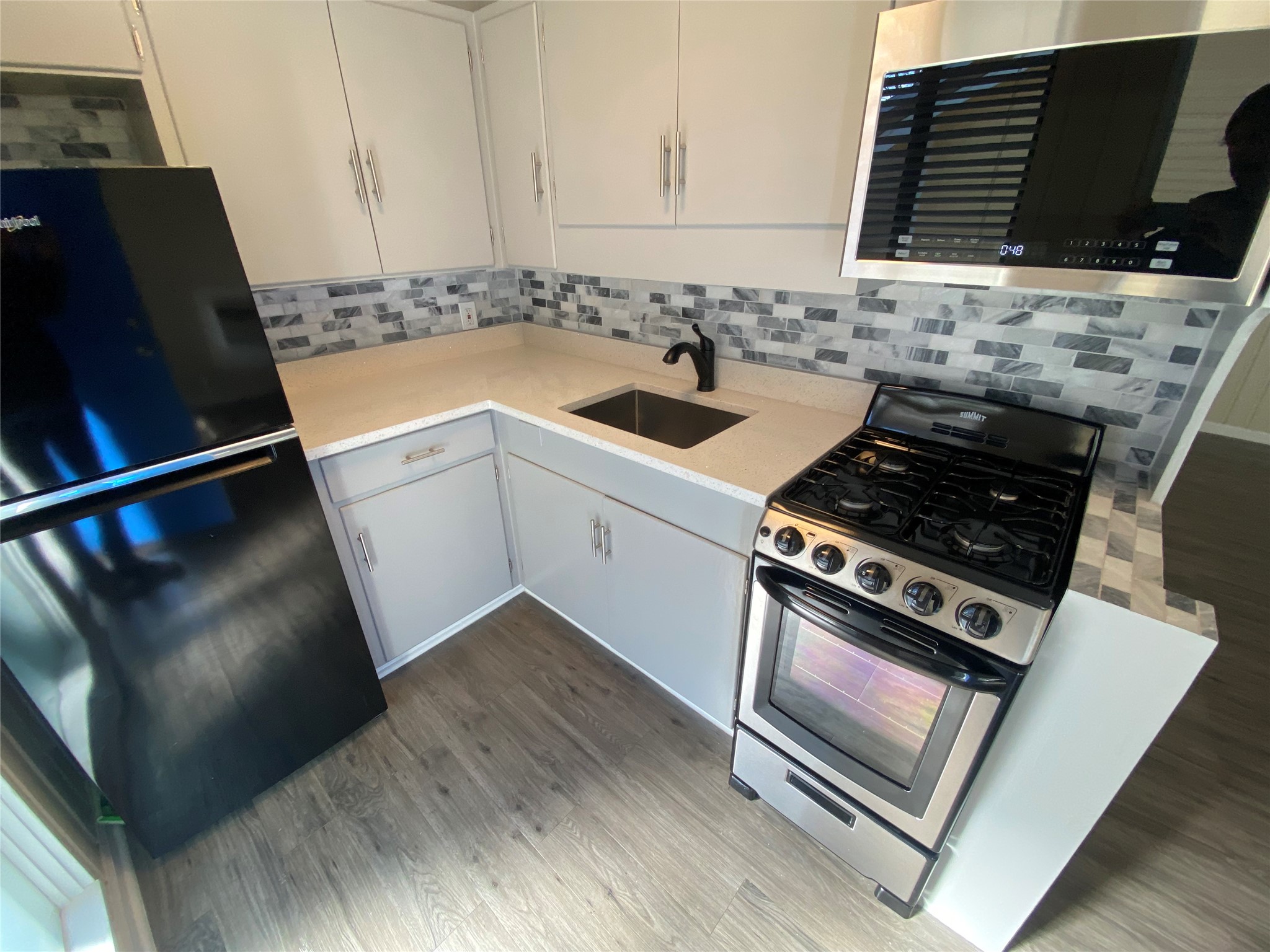 3010 Fruth Street, Unit B Austin, TX 78705 - Photo 5 of 32 Modern kitchen with sleek counters and a stylish backsplash, ready for culinary adventures.