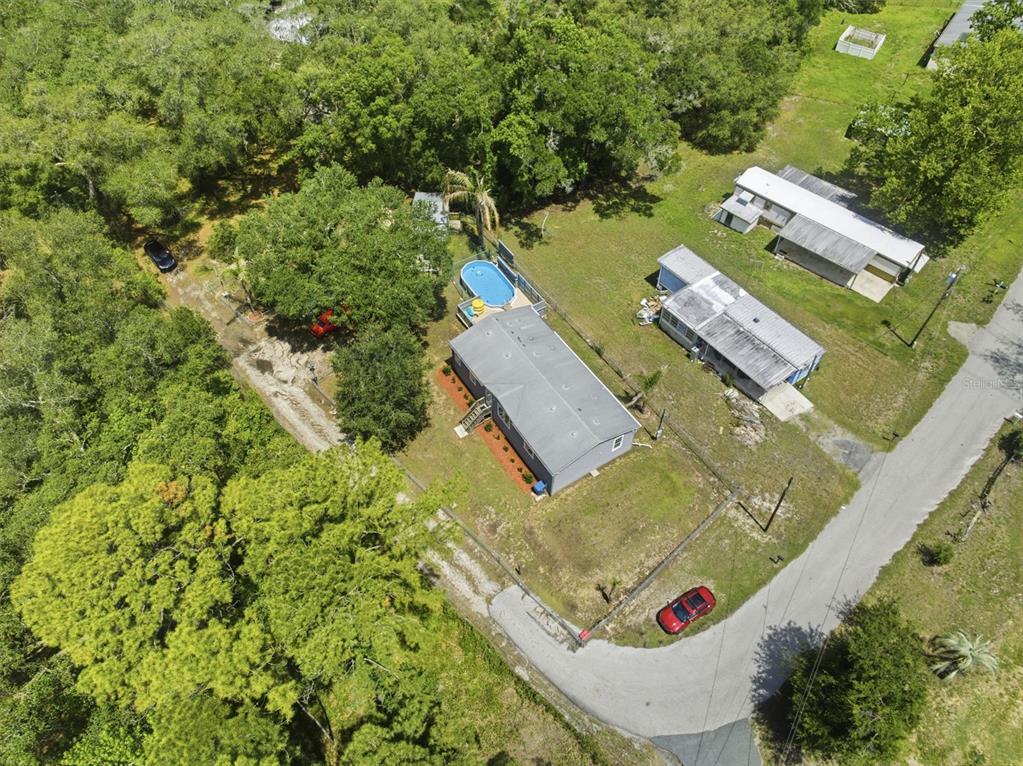 3183 Cedley Road Dade City, FL 33523 - Photo 31 of 48 an aerial view of a house with a yard and trees