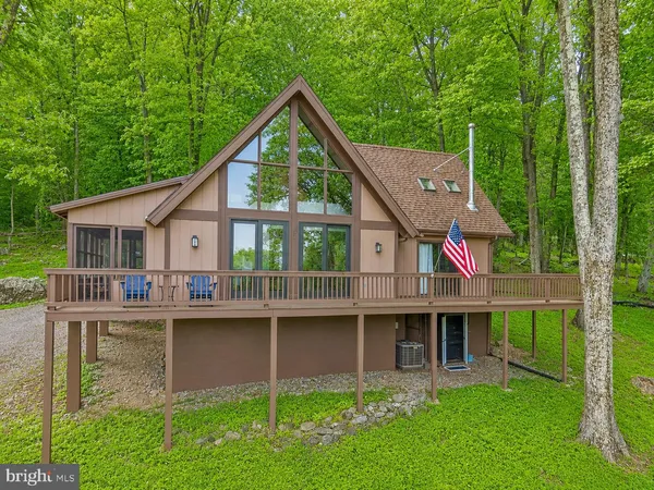 a view of a house with a yard and sitting area