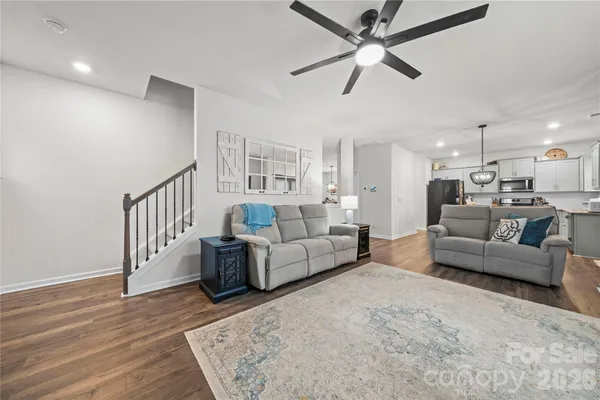 a living room with furniture and a wooden floor