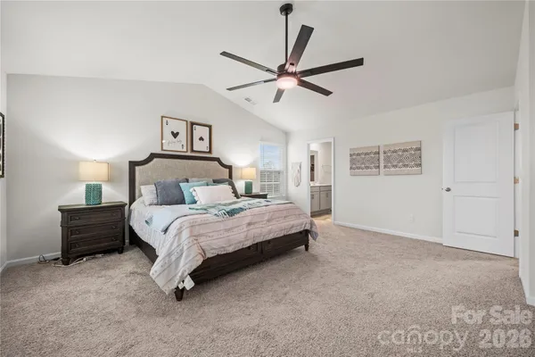 a bedroom with a bed and painting on the wall