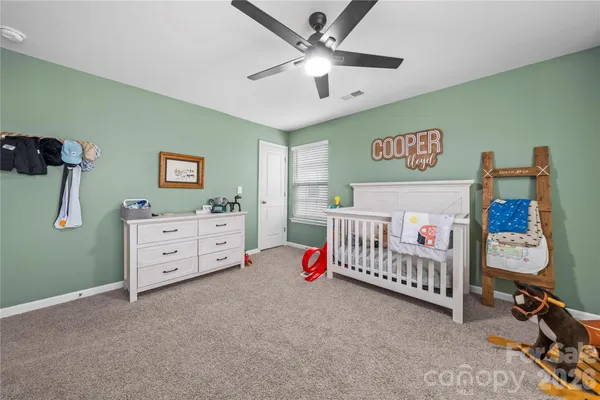 a room with furniture and baby crib