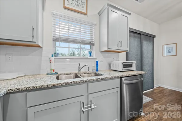 a kitchen with a sink cabinets and window