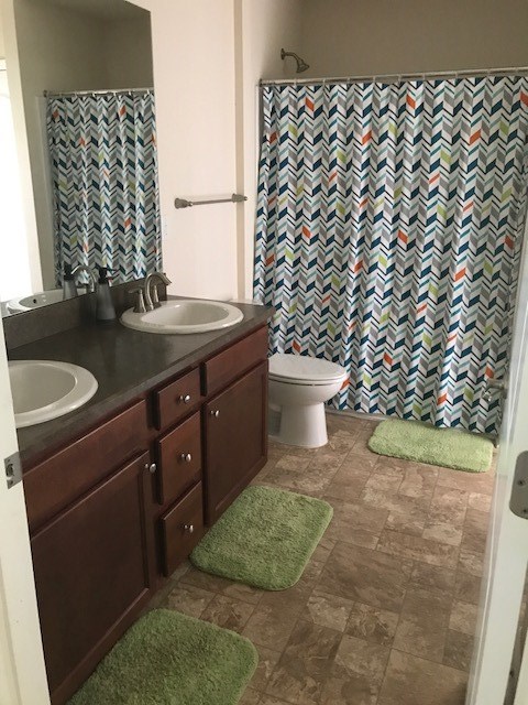 88392 Maybourne Road Yulee, FL 32097 - Photo 13 of 34 a bathroom with a granite countertop sink and a toilet