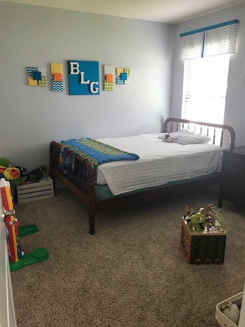 88392 Maybourne Road Yulee, FL 32097 - Photo 14 of 34 a bedroom with a bed and a couch
