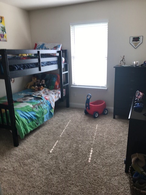 88392 Maybourne Road Yulee, FL 32097 - Photo 15 of 34 a bedroom with a bed and a window
