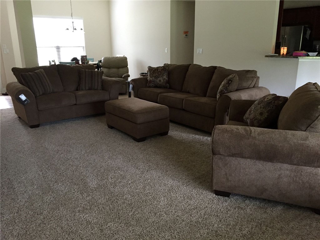 88392 Maybourne Road Yulee, FL 32097 - Photo 2 of 34 a living room with furniture and a flat screen tv