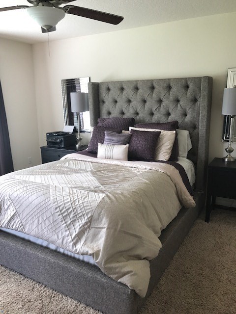 88392 Maybourne Road Yulee, FL 32097 - Photo 23 of 34 a large bed sitting in a bedroom next to a lamp