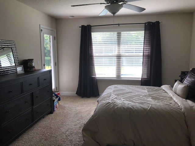 88392 Maybourne Road Yulee, FL 32097 - Photo 24 of 34 a bedroom with a bed and a dresser