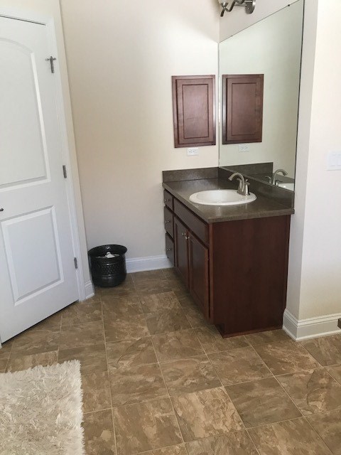 88392 Maybourne Road Yulee, FL 32097 - Photo 27 of 34 a bathroom with a sink vanity and mirror