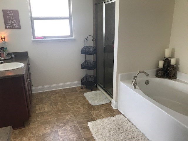88392 Maybourne Road Yulee, FL 32097 - Photo 28 of 34 a bathroom with a tub sink and mirror