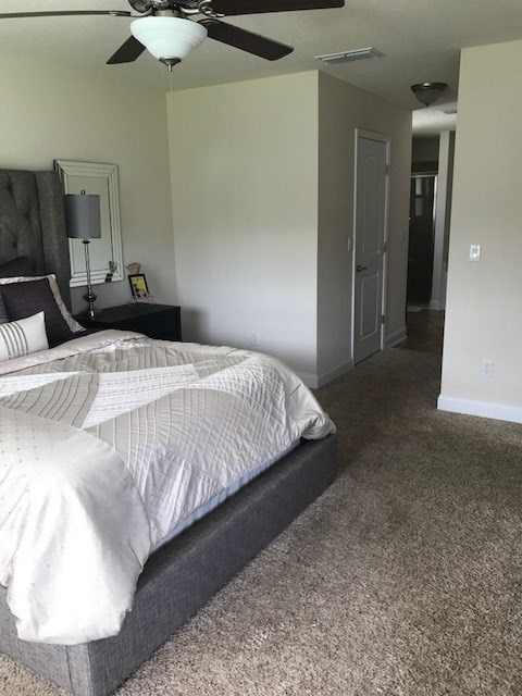 88392 Maybourne Road Yulee, FL 32097 - Photo 29 of 34 a bedroom with a bed and a chandelier