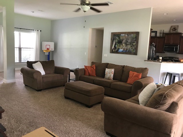 88392 Maybourne Road Yulee, FL 32097 - Photo 30 of 34 a living room with furniture ceiling fan and a window