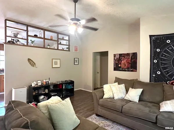 a living room with furniture and a chandelier