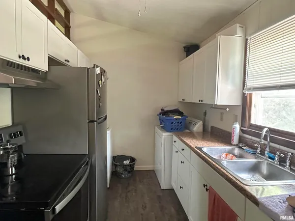 a kitchen with a sink stove and cabinets