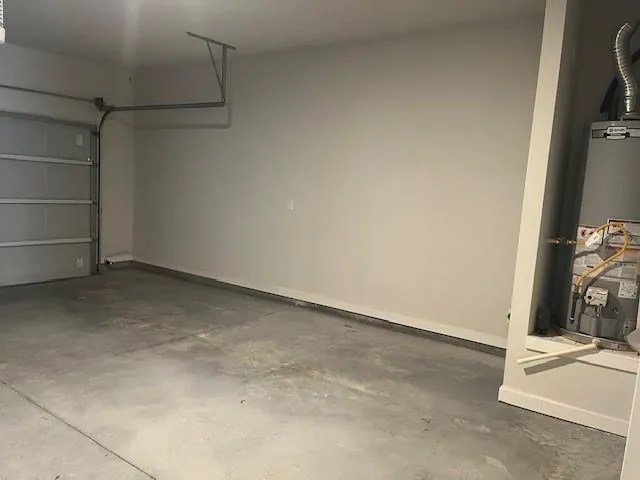 a kitchen with stainless steel appliances granite countertop a stove a refrigerator a sink and dishwasher with wooden floors