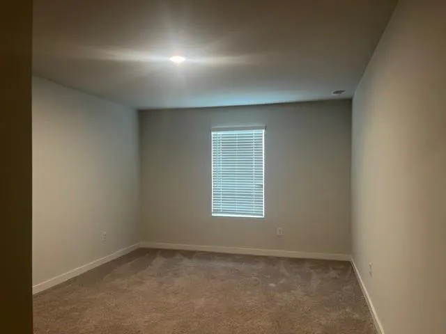 an empty room that has a window in it