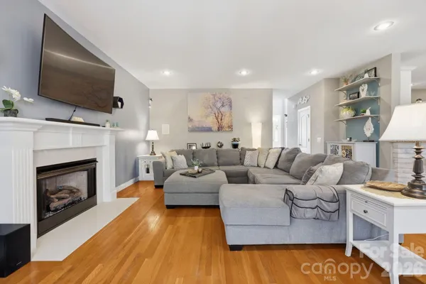 a living room with furniture fireplace and flat screen tv