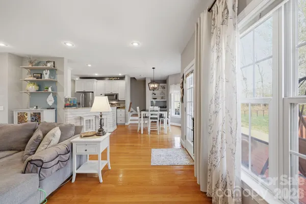 a living room with lots of furniture and a large window