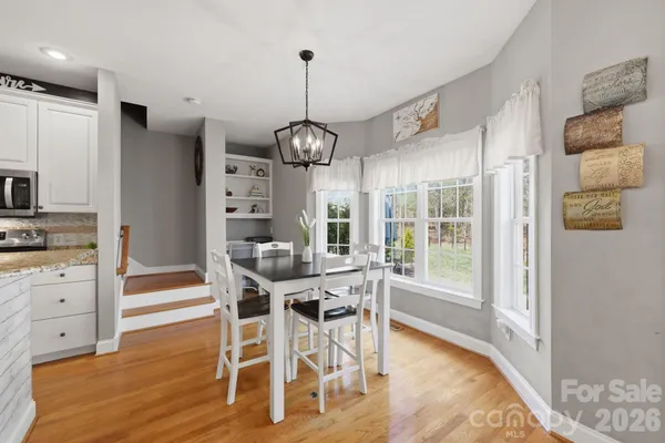 a view of a dining room with furniture wooden floor and chandelier