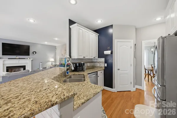a kitchen with stainless steel appliances granite countertop a refrigerator oven stove a sink and a refrigerator