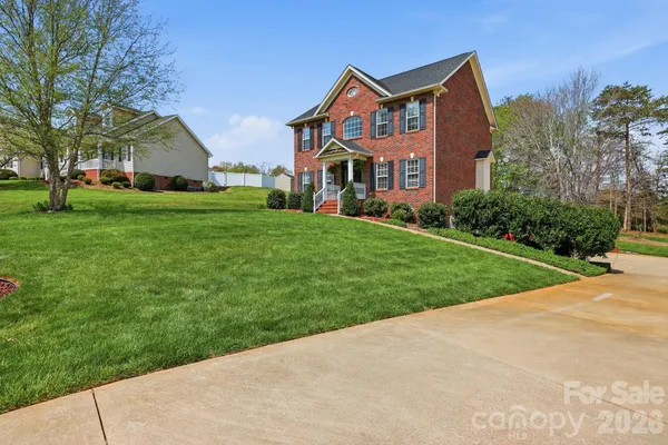 a front view of house with yard and green space