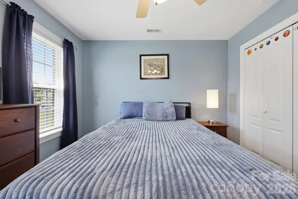 a bedroom with a large bed and a window