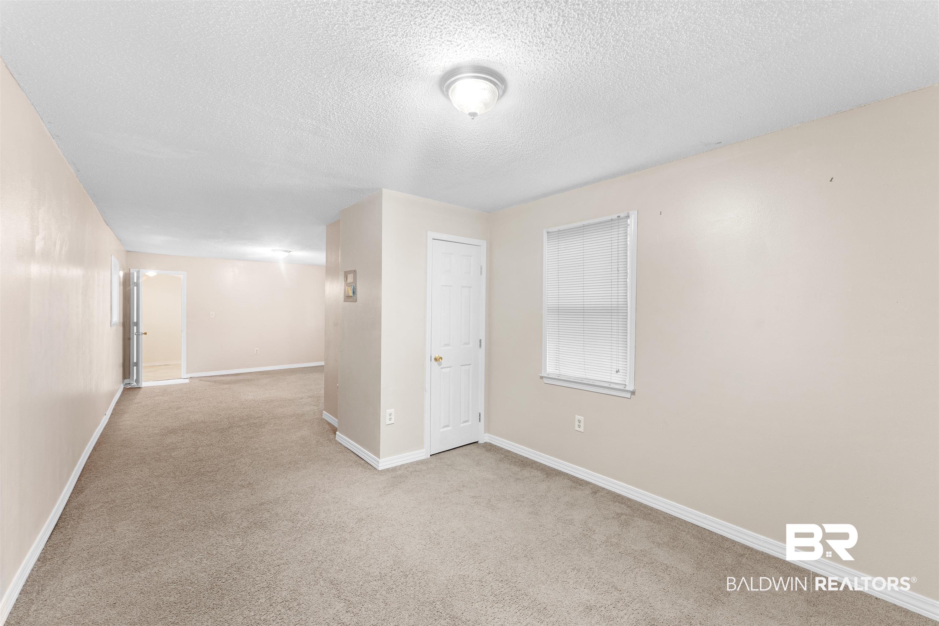 5551 Springer Court Theodore, AL 36582 - Photo 26 of 37 Spare room featuring a textured ceiling and carpet