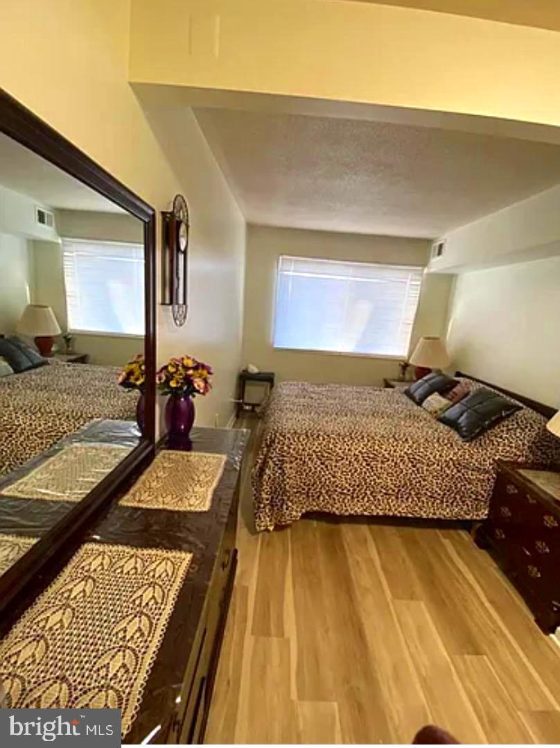 1836 Metzerott Road, Unit 916 Adelphi, MD 20783 - Photo 12 of 29 a bedroom with a bed and wooden floor