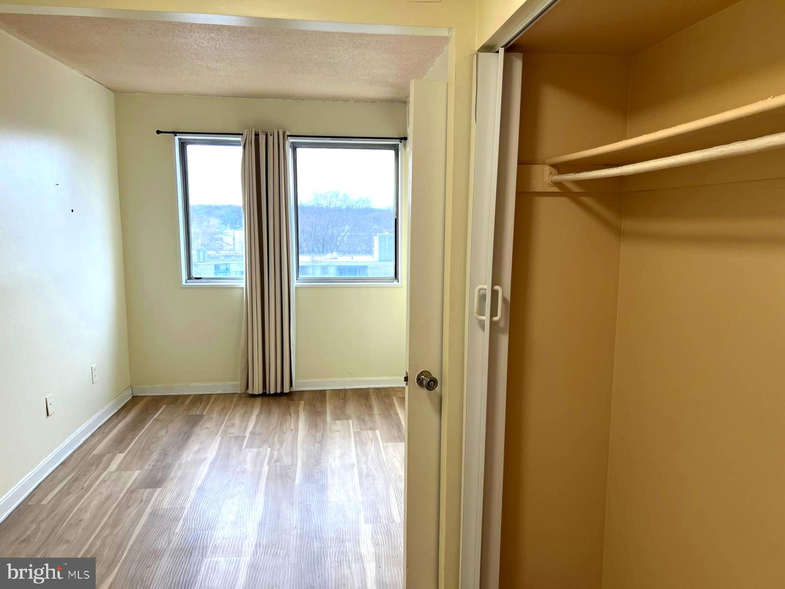 1836 Metzerott Road, Unit 916 Adelphi, MD 20783 - Photo 14 of 29 an empty room with wooden floor and a window