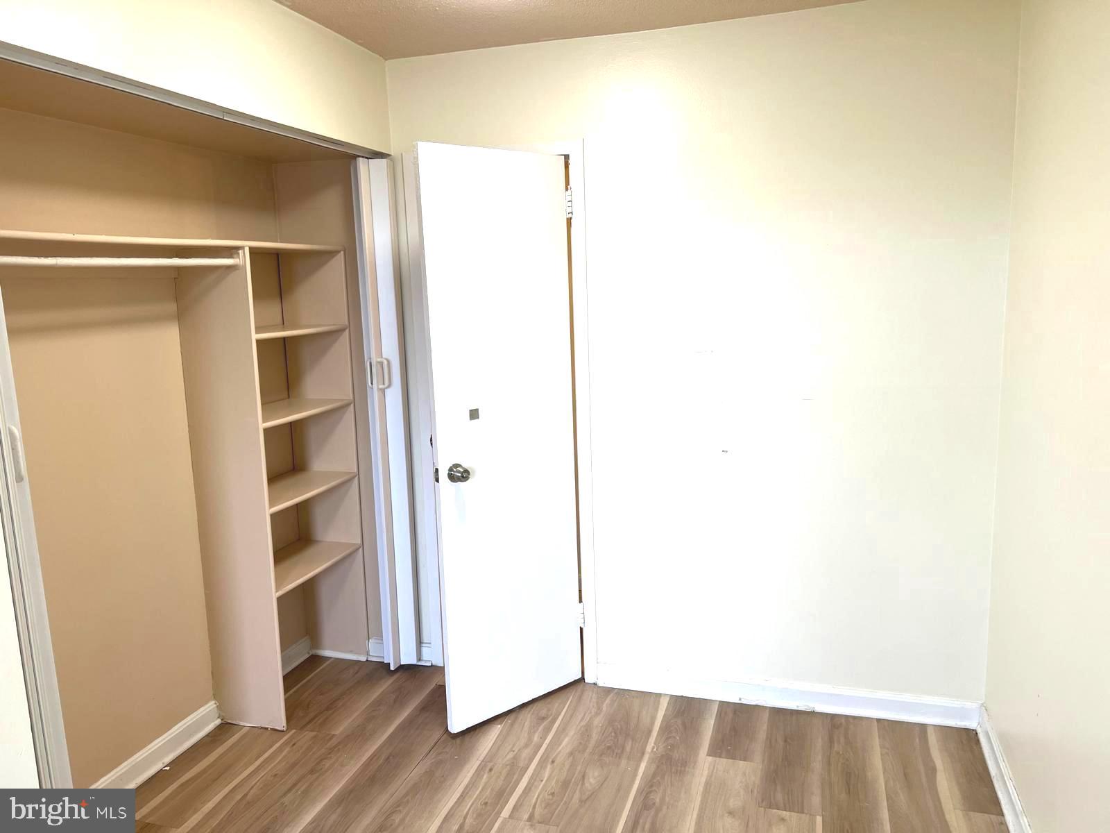 1836 Metzerott Road, Unit 916 Adelphi, MD 20783 - Photo 17 of 42 a view of walk in closet with wooden floor
