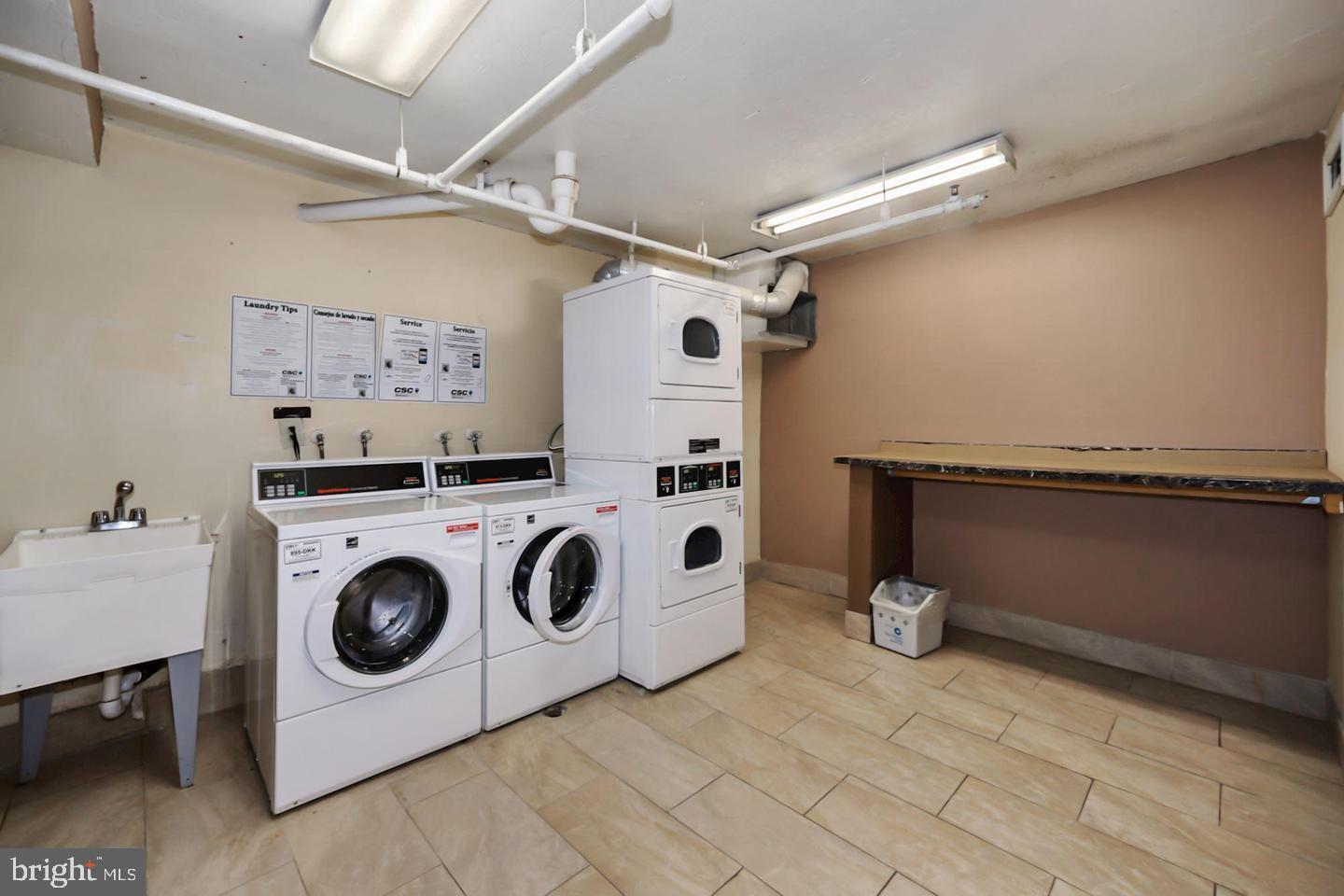 1836 Metzerott Road, Unit 916 Adelphi, MD 20783 - Photo 24 of 29 a utility room with dryer and washer