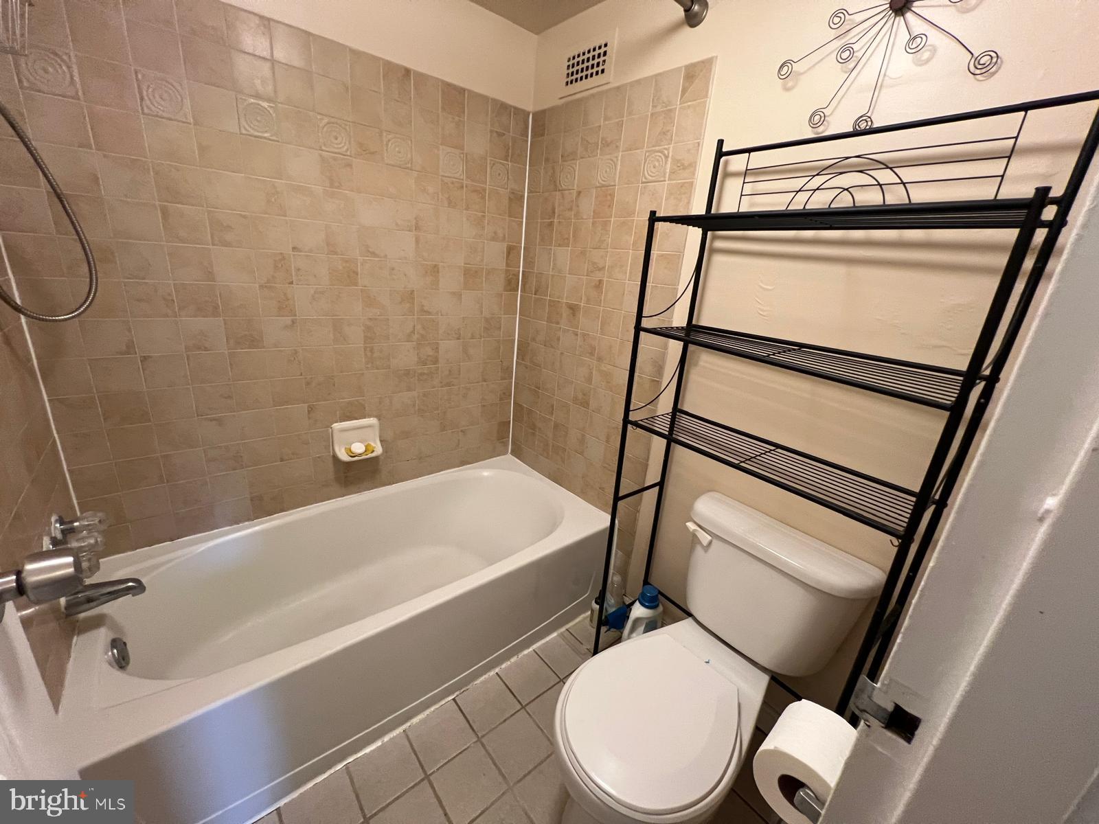 1836 Metzerott Road, Unit 916 Adelphi, MD 20783 - Photo 26 of 29 a white toilet sitting next to a bath tub