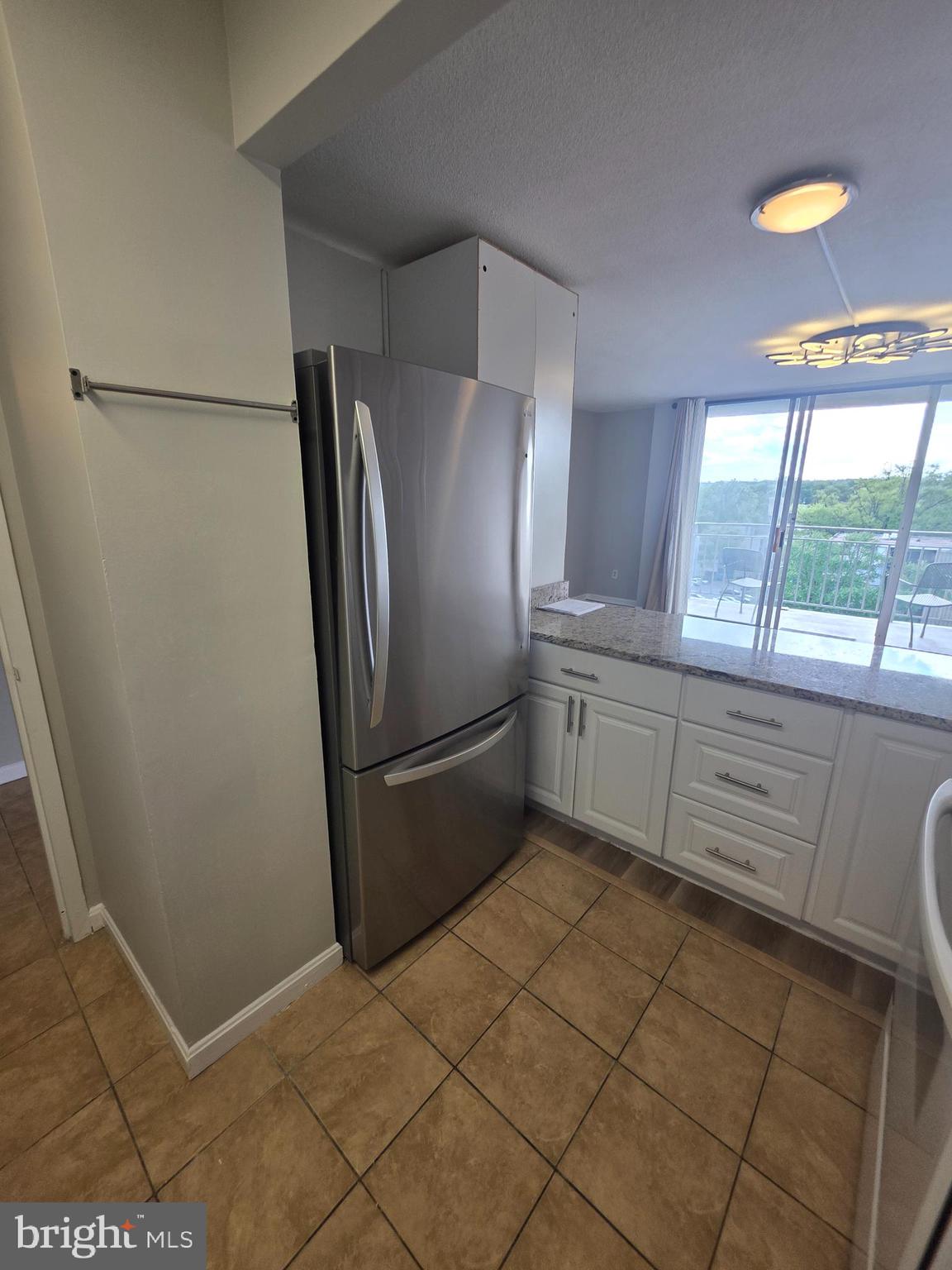 1836 Metzerott Road, Unit 916 Adelphi, MD 20783 - Photo 28 of 42 a kitchen with stainless steel appliances a refrigerator sink and cabinets