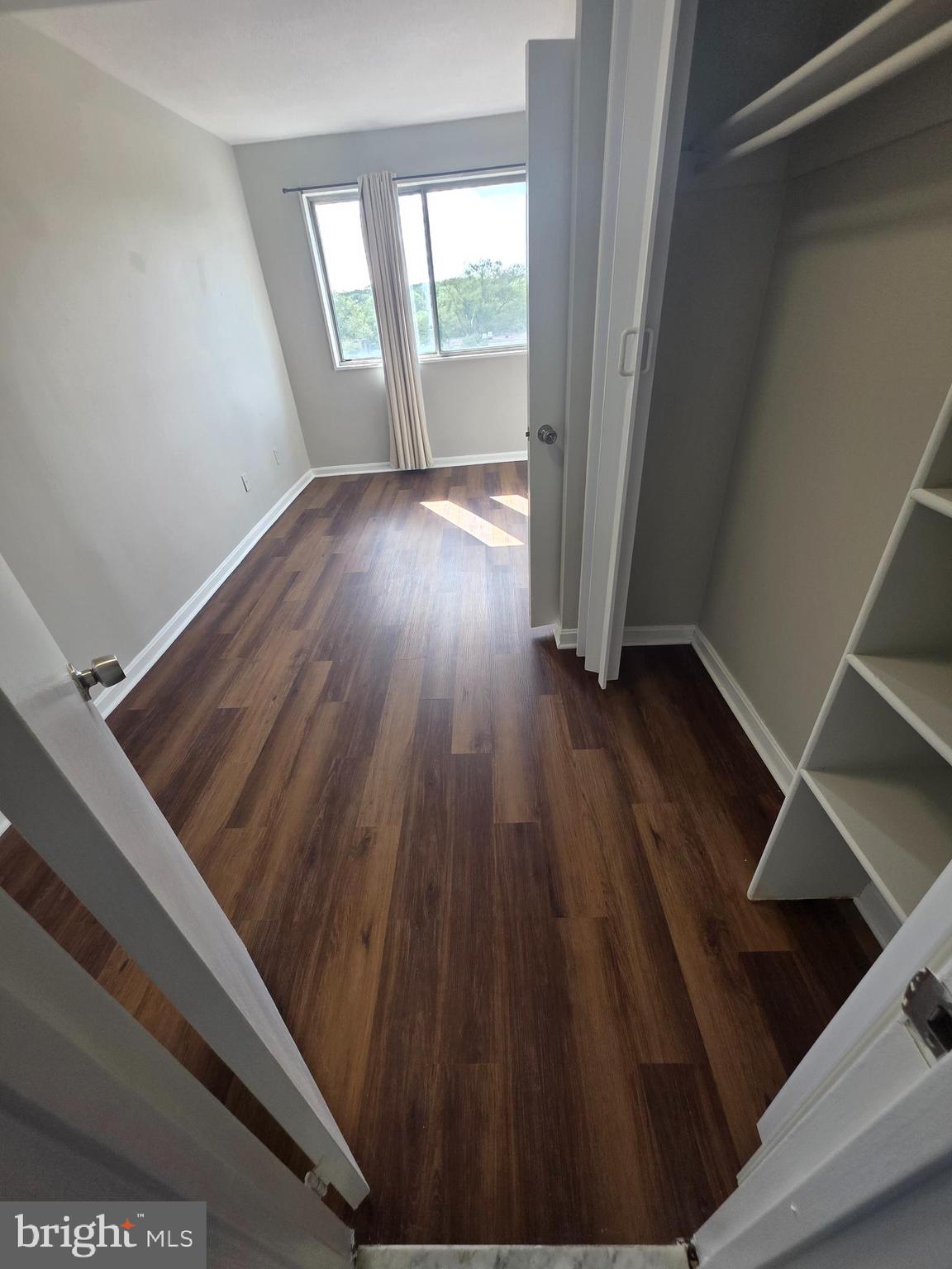 1836 Metzerott Road, Unit 916 Adelphi, MD 20783 - Photo 34 of 42 a view of an empty room and wooden floor