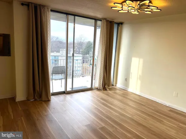 a view of hallway with furniture and a window