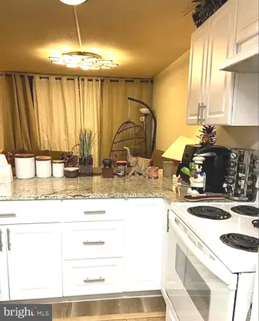 a kitchen with stainless steel appliances granite countertop a sink a stove and a microwave