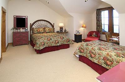 3892 Daybreak Ridge Road Avon, CO 81620 - Photo 12 of 24 a bedroom with a bed and dresser with large mirror