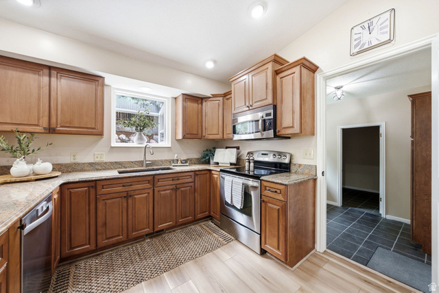 11875 South Elm Ridge Road Sandy, UT 84094 - Photo 12 of 53 Kitchen featuring light wood-finish flooring, recessed lighting, wood cabinetry, stone countertops, and stainless steel appliances