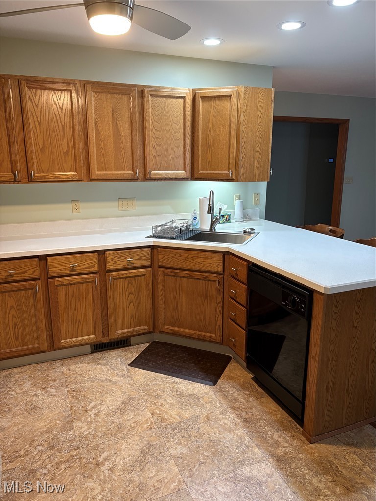 6695 Clingan Road, Unit 24 Youngstown, OH 44514 - Photo 5 of 26 Kitchen featuring light countertops, brown cabinets, dishwasher, a peninsula, and recessed lighting
