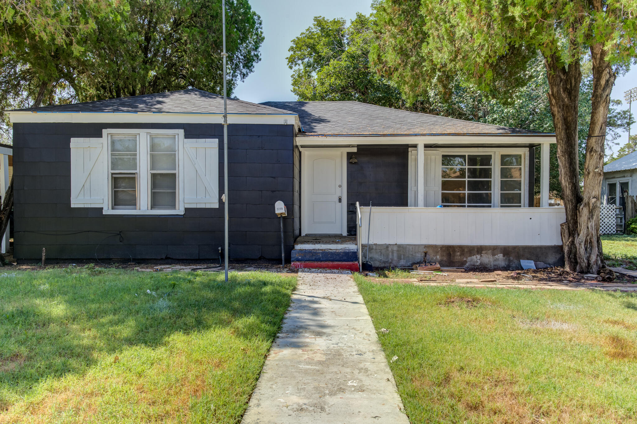 a front view of a house with yard and green space