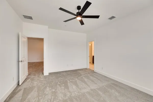 a view of a livingroom with a ceiling fan and window