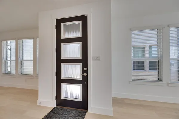 an empty room with windows and closet